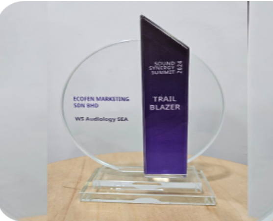 A glass award with a circular base and a vertical blue panel labeled "Sound Synergy Summit 2023" and "Trail Blazer." The text on the base reads "ECOFEN Marketing SDN BHD" and "WIS Audiology SEA.